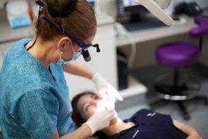 Dentist inspects patient before tooth filling